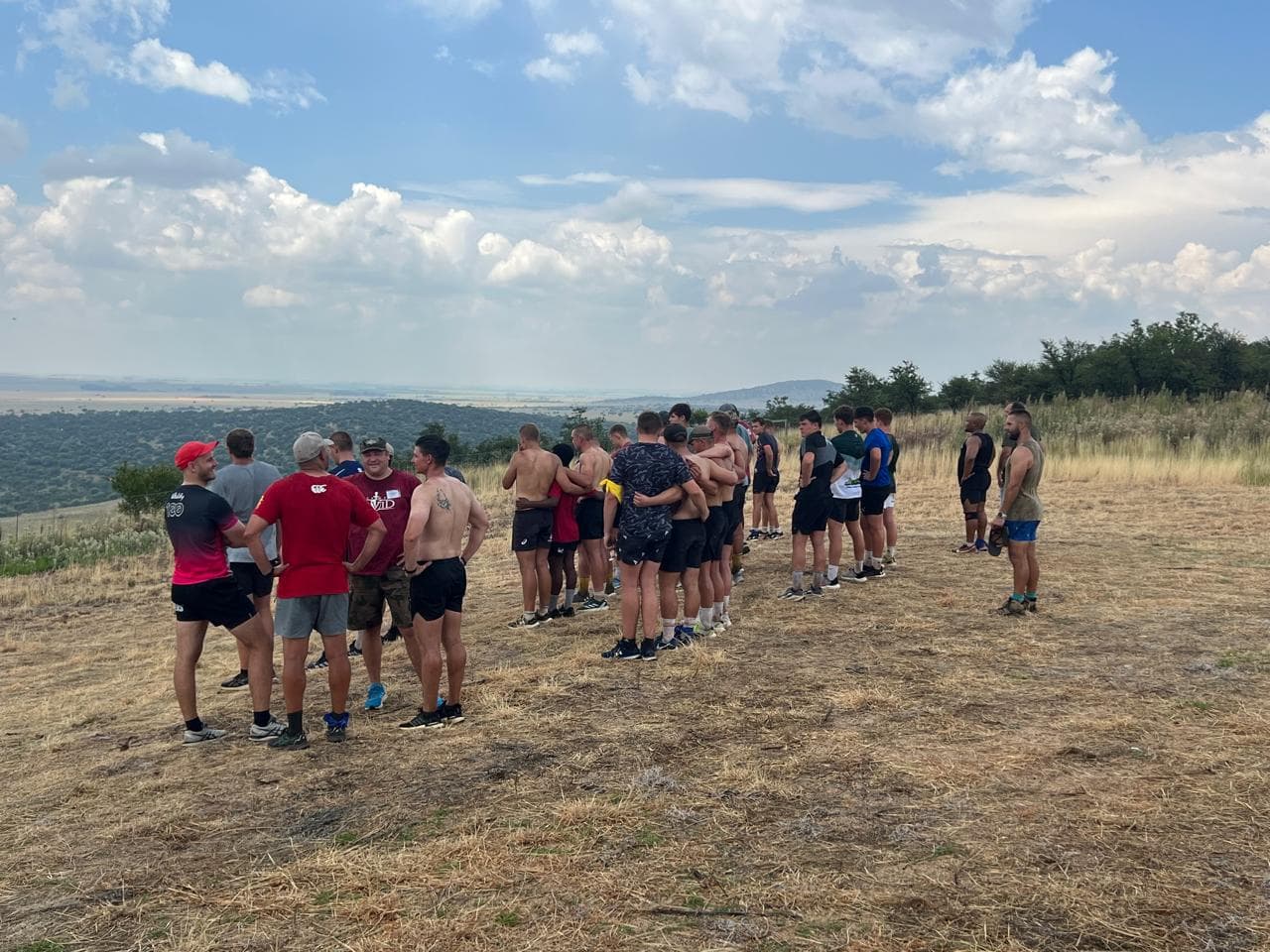 Men hiking through rugged terrain on the Battle to Fight trail